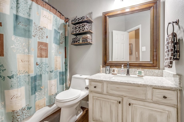 bathroom featuring walk in shower, toilet, wood-type flooring, and vanity