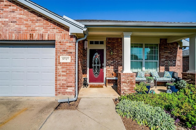 entrance to property featuring a garage and a porch