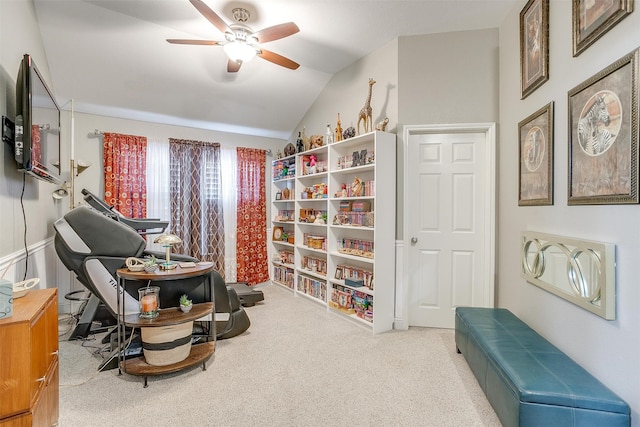 living area featuring light carpet, vaulted ceiling, and ceiling fan