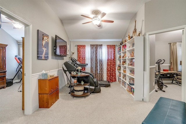 living area featuring vaulted ceiling, carpet floors, and ceiling fan