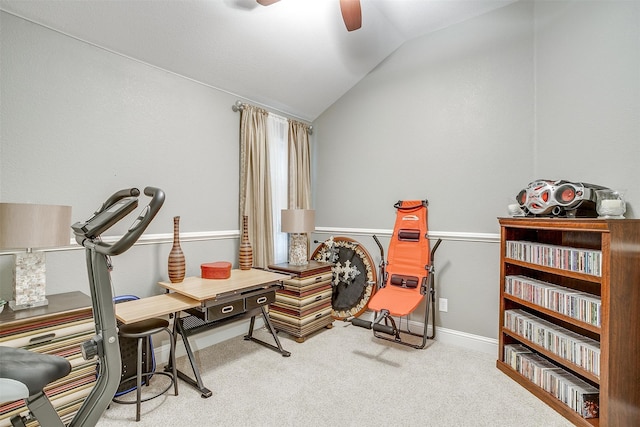 living area with carpet flooring, vaulted ceiling, and ceiling fan