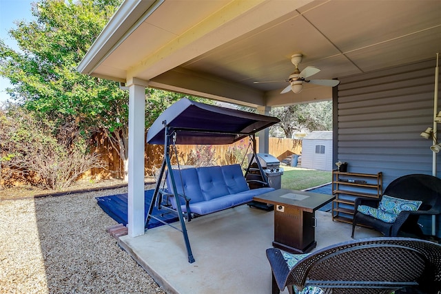 view of patio featuring area for grilling, ceiling fan, a shed, and an outdoor hangout area