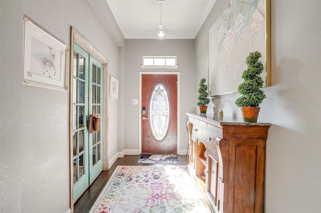 entryway with dark hardwood / wood-style floors and crown molding