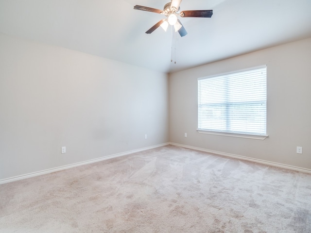 empty room featuring light colored carpet and ceiling fan