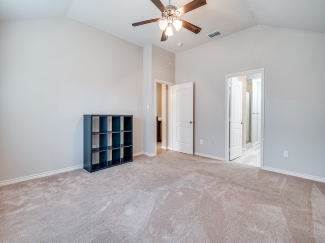 unfurnished bedroom featuring lofted ceiling, ceiling fan, light carpet, and ensuite bathroom