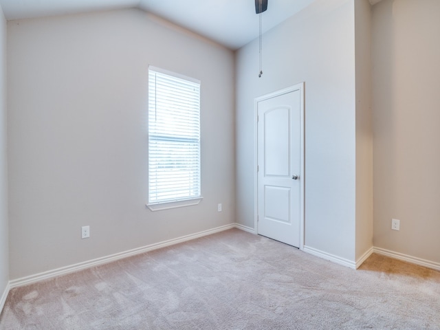 empty room with light carpet and lofted ceiling