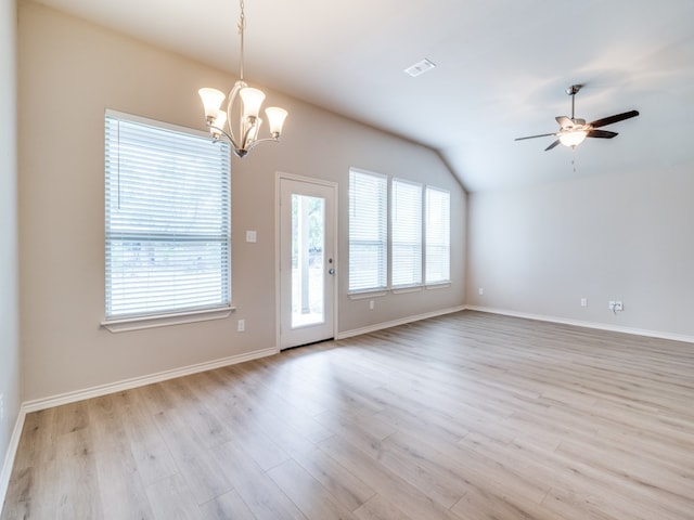 interior space with light wood-type flooring, ceiling fan with notable chandelier, and vaulted ceiling