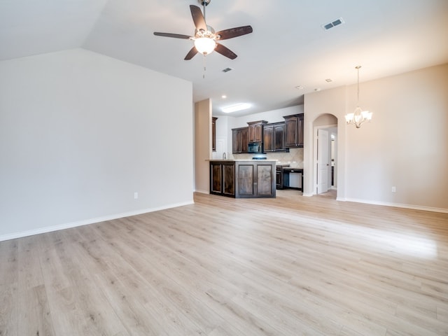 unfurnished living room featuring ceiling fan with notable chandelier, lofted ceiling, and light hardwood / wood-style flooring