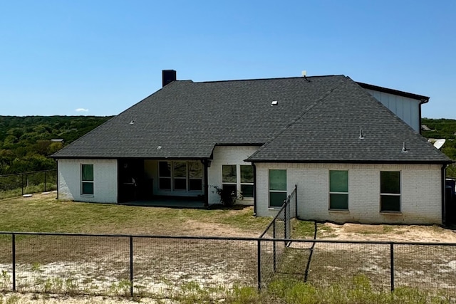 back of property featuring a lawn and a patio