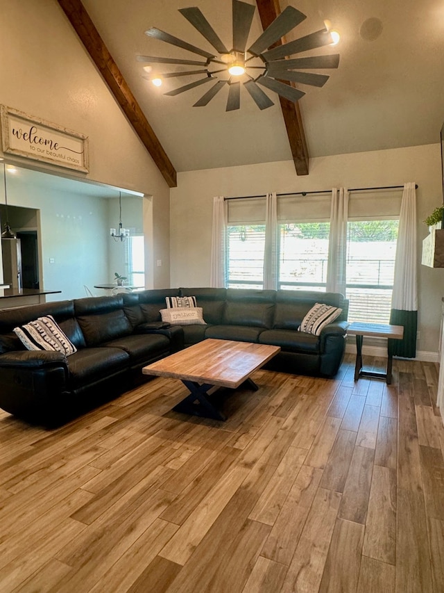 living room with hardwood / wood-style floors, ceiling fan, plenty of natural light, and lofted ceiling with beams