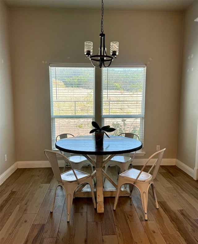 dining space with an inviting chandelier, light hardwood / wood-style floors, and a healthy amount of sunlight