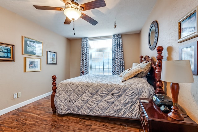 bedroom with ceiling fan and dark wood-type flooring