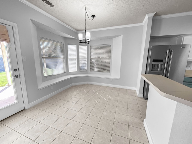 unfurnished dining area with ornamental molding, plenty of natural light, a textured ceiling, and a chandelier