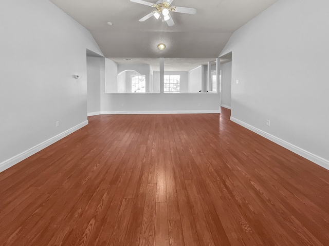 unfurnished living room with lofted ceiling, ceiling fan, and wood-type flooring