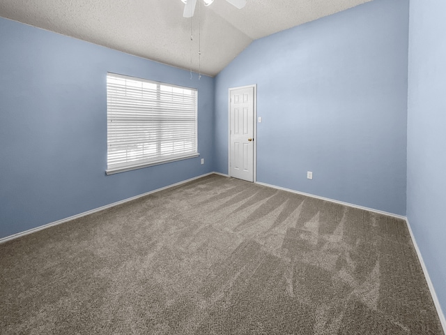 carpeted spare room with lofted ceiling, ceiling fan, and a textured ceiling