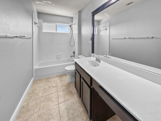 full bathroom with a textured ceiling, vanity, tile patterned flooring, toilet, and tiled shower / bath combo