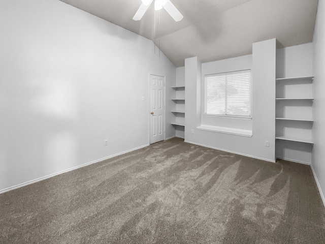 interior space featuring lofted ceiling, ceiling fan, and carpet