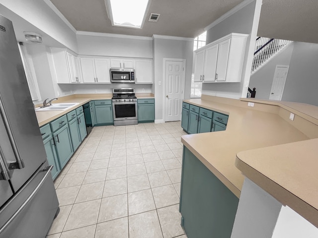 kitchen featuring crown molding, appliances with stainless steel finishes, sink, and white cabinets