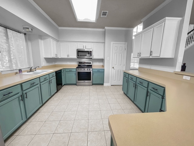 kitchen featuring ornamental molding, stainless steel appliances, sink, and white cabinets