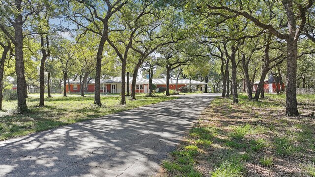 view of property's community featuring a wooden deck and a yard