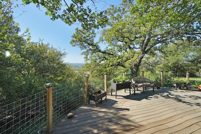 wooden deck with an outdoor living space with a fire pit