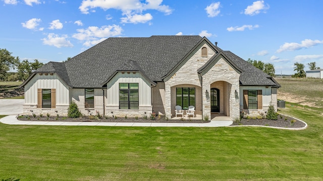 view of front of property featuring a front lawn and central air condition unit