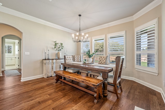 dining space with a notable chandelier, dark hardwood / wood-style flooring, and crown molding