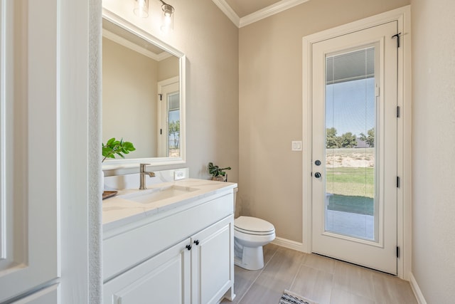 bathroom featuring crown molding, vanity, and toilet