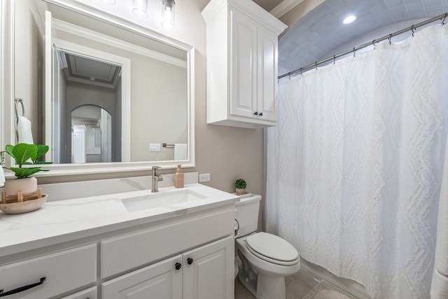 bathroom with a shower with shower curtain, toilet, ornamental molding, and vanity