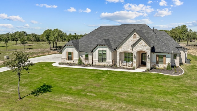 french country style house featuring a front yard