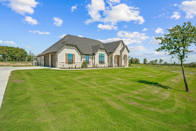 french country home featuring a front lawn and a garage