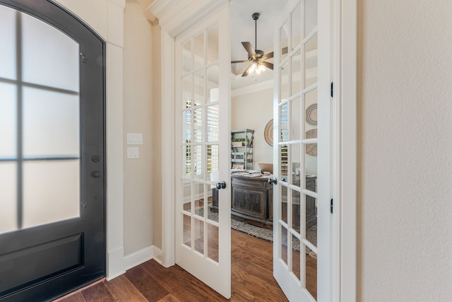 doorway with dark wood-type flooring, ceiling fan, crown molding, and french doors