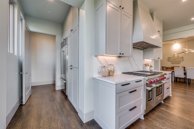 kitchen with white cabinets, custom exhaust hood, high quality appliances, and dark hardwood / wood-style floors