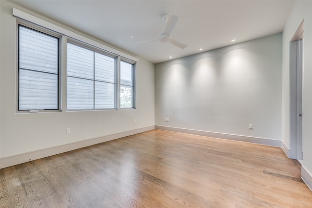 empty room with light wood-type flooring and ceiling fan