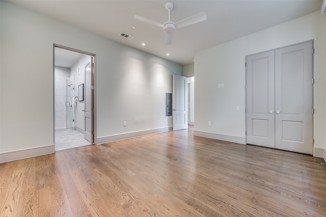 unfurnished bedroom with ceiling fan, light hardwood / wood-style flooring, and ensuite bathroom