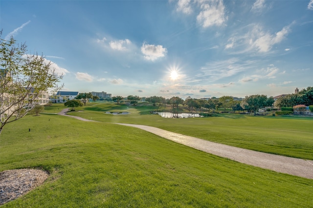 surrounding community with a lawn and a water view