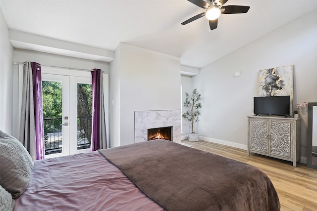 bedroom with ceiling fan, light hardwood / wood-style floors, french doors, and access to exterior