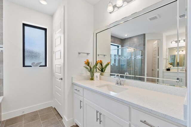 bathroom with vanity, a shower with shower door, and tile patterned floors