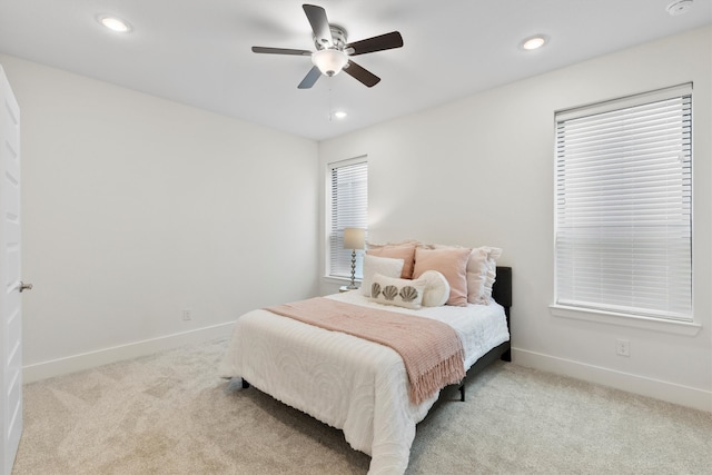 bedroom with ceiling fan and light carpet