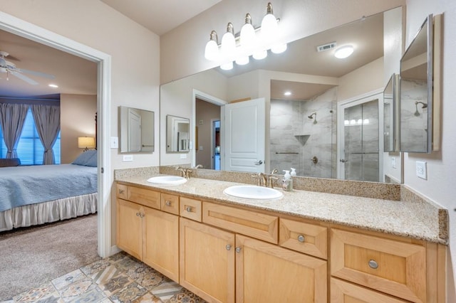 bathroom featuring an enclosed shower, vanity, and ceiling fan