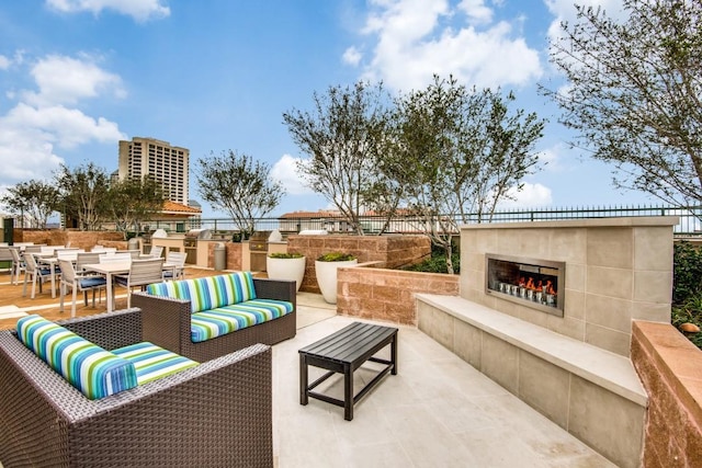 view of patio / terrace with an outdoor living space with a fireplace