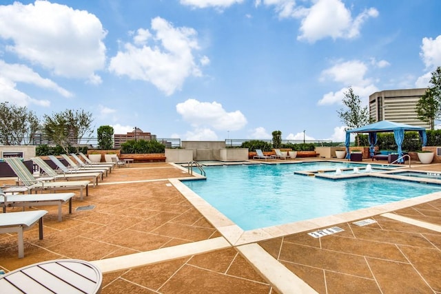 view of pool with a gazebo, a jacuzzi, and a patio