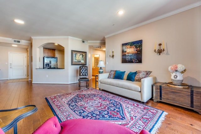 living room featuring hardwood / wood-style floors and ornamental molding