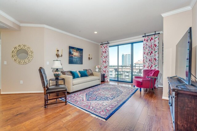 living room featuring hardwood / wood-style floors, a notable chandelier, and ornamental molding