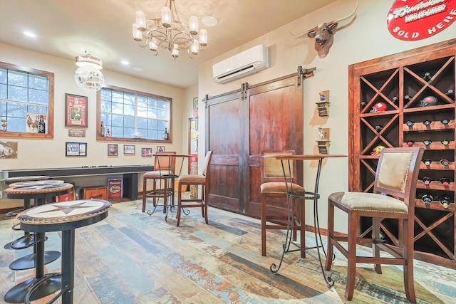 wine room with a barn door, an inviting chandelier, and a wall mounted air conditioner