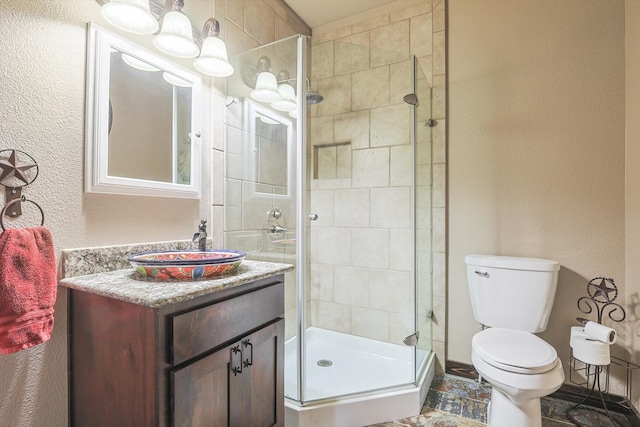 bathroom featuring vanity, toilet, and walk in shower