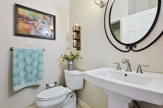 bathroom featuring toilet and sink