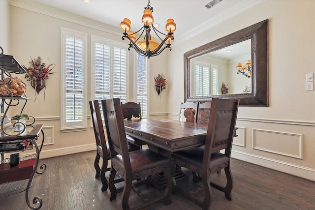 dining area with ornamental molding, a notable chandelier, and dark hardwood / wood-style floors