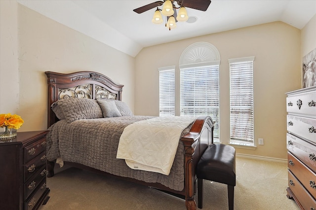 carpeted bedroom with vaulted ceiling and ceiling fan