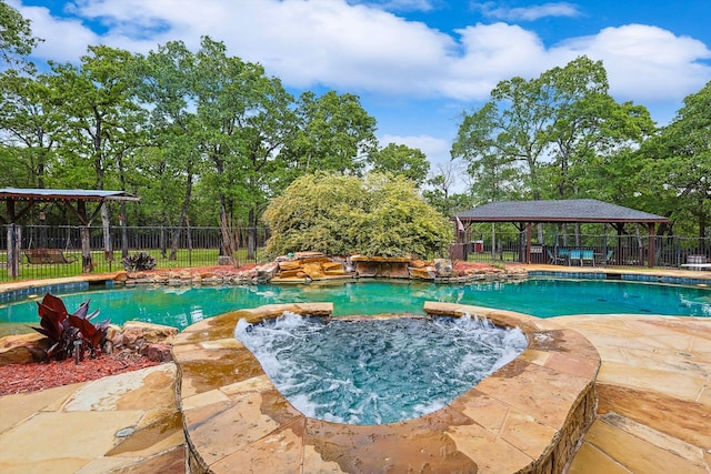 view of pool featuring an in ground hot tub and a gazebo